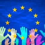Image of hands on the background of the European flag. make a choice. vote. Cast your vote for Europe