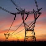 Electricity power pylons over sunset